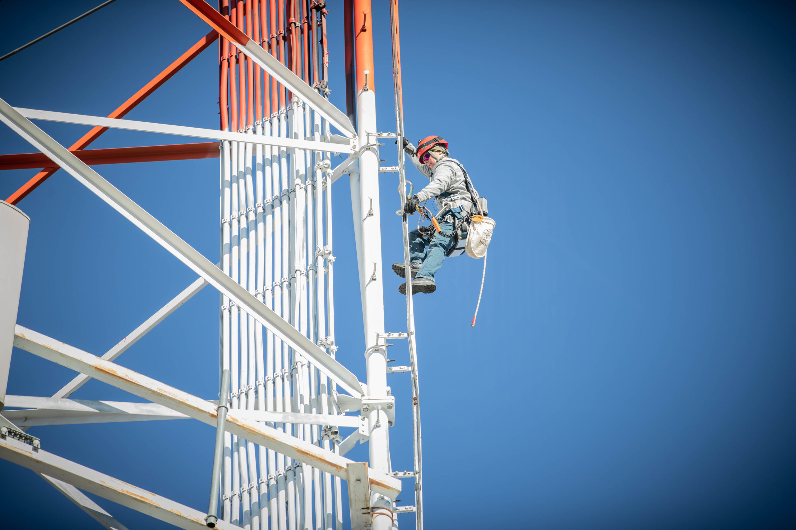 woman climbing 5G cell tower
